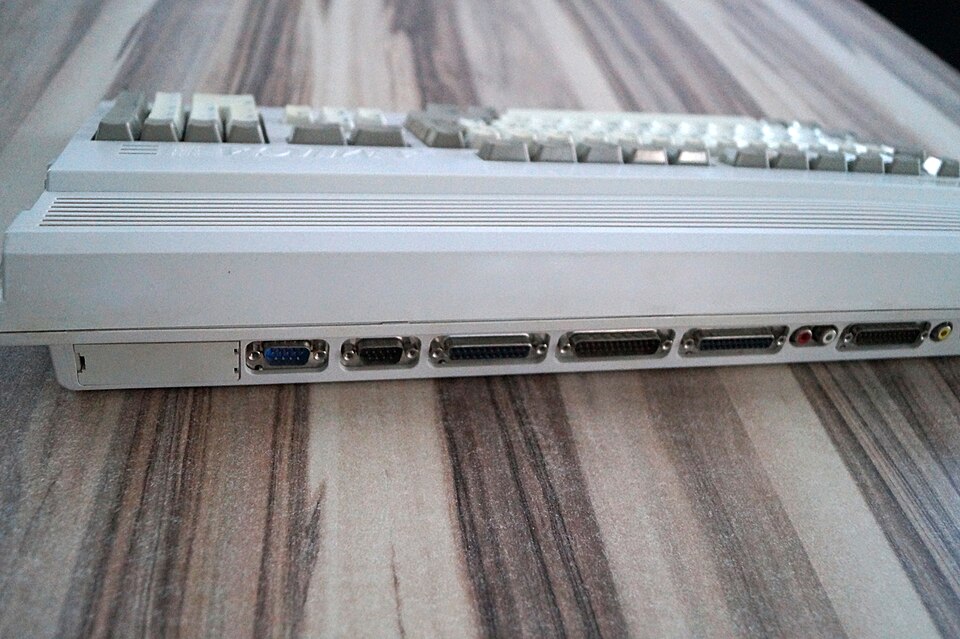 Real Commodore Amiga 1200 photographed from behind showing its actual wedge profile and connector openings